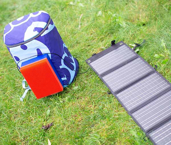 Nomadic.cool connected to a small solar panel — full autonomy for days